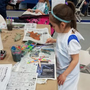 A child painting a starfish